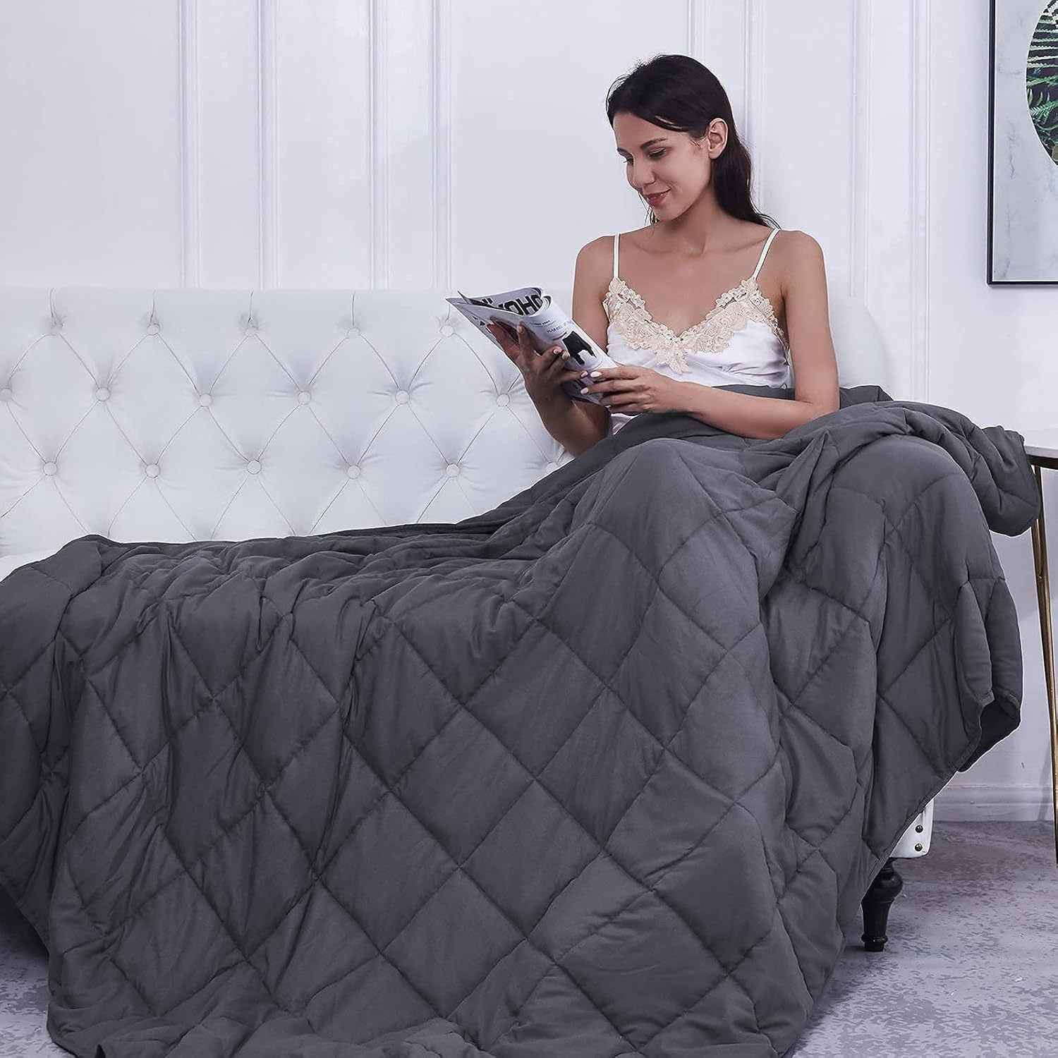 Person relaxing peacefully under therapeutic gravity weighted blanket