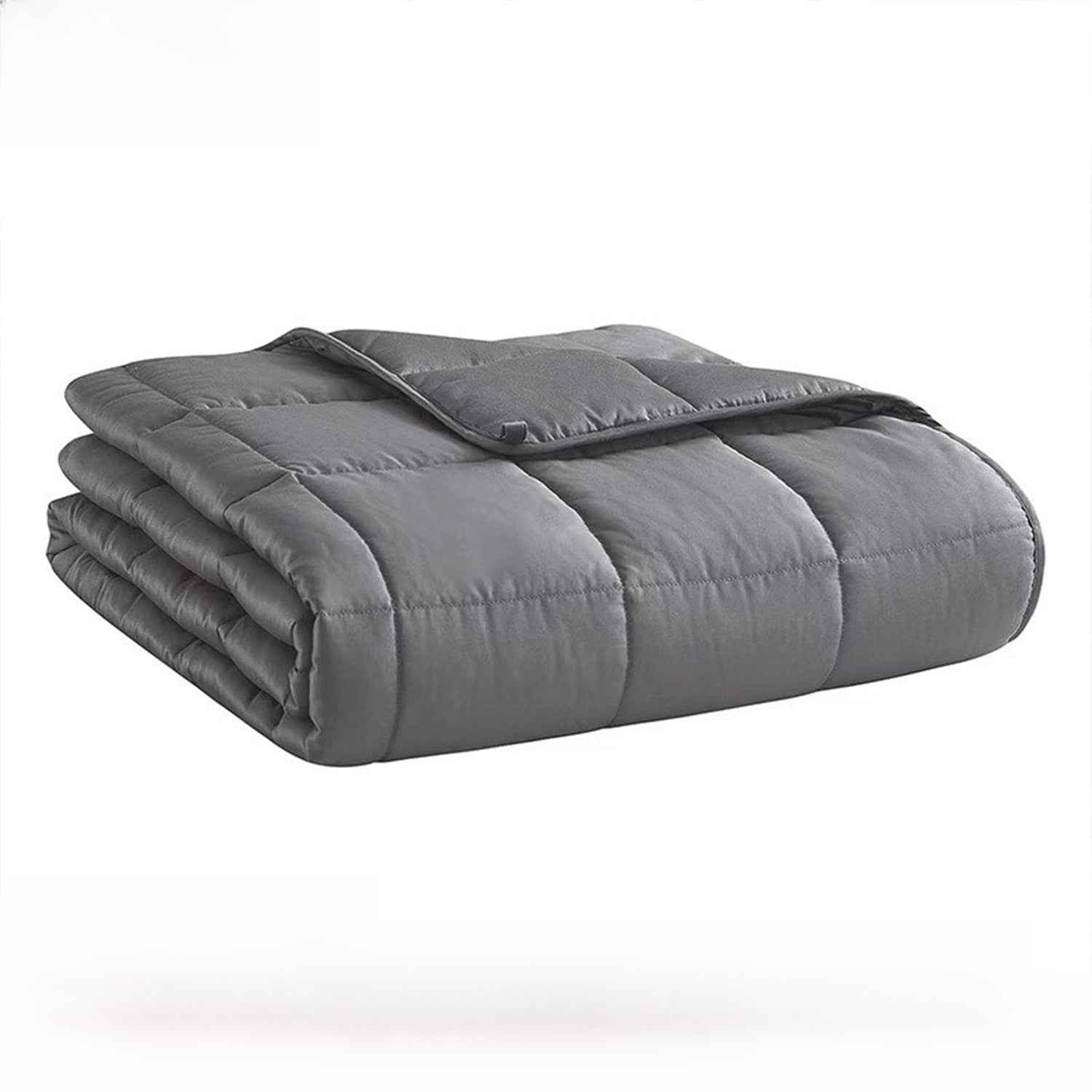 Person reading under calming weighted blanket on couch